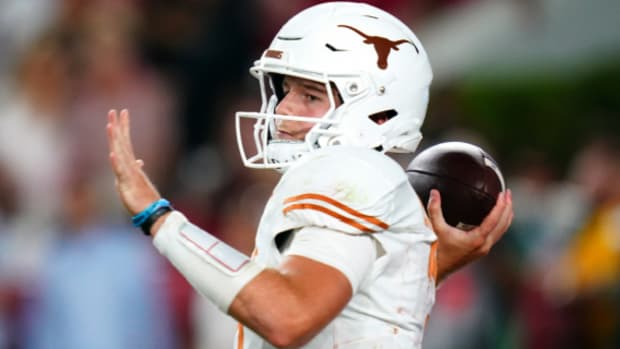 Texas Longhorns quarterback Quinn Ewers on a pass attempt during a college football game.